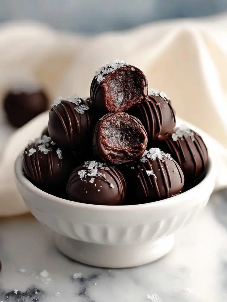 Delicious brownie truffles coated in chocolate and sprinkled with colorful toppings on a wooden surface.