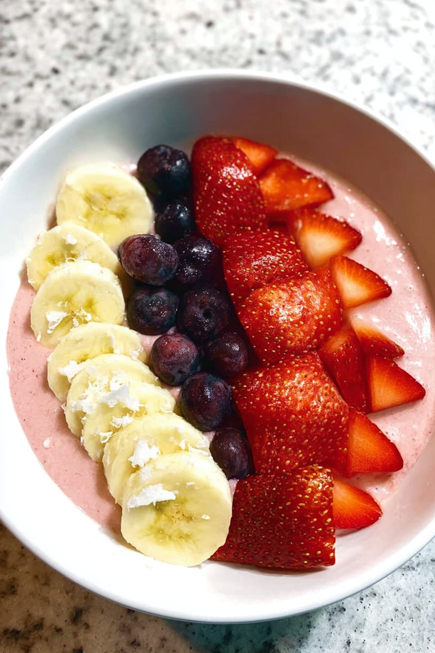 5-minute fruit smoothie bowl topped with sliced fruits and granola, perfect for breakfast.