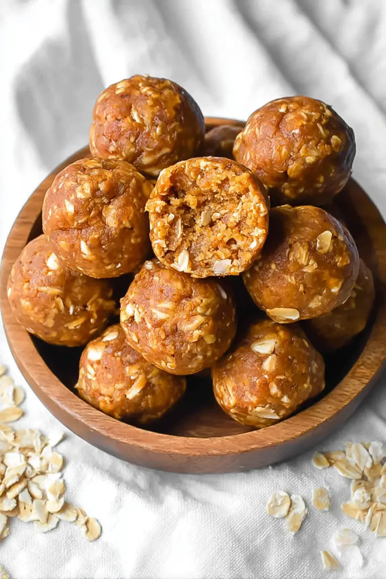 Close-up view of pumpkin protein balls on a wooden platter with pumpkin seeds and spice.