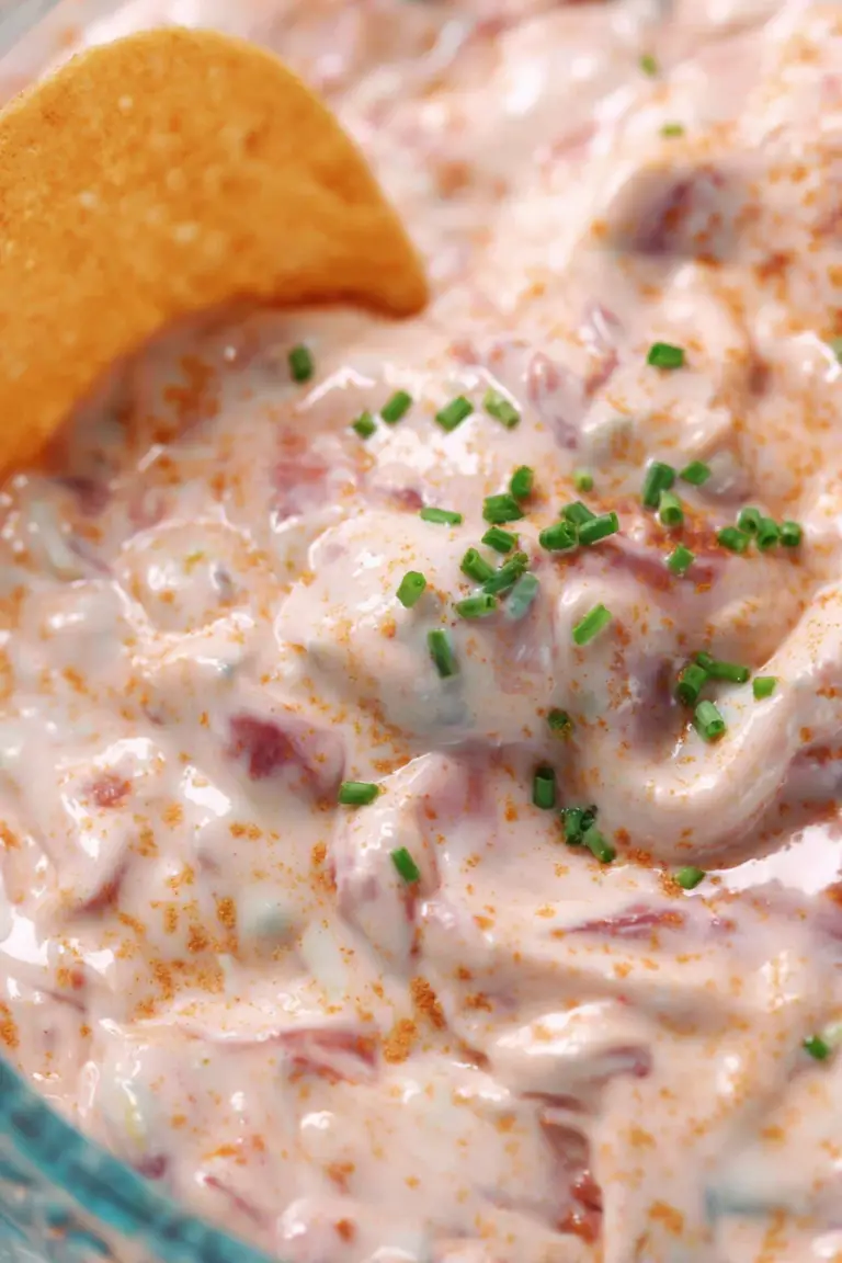Creamy high-protein pool dip served with tortilla chips and fresh vegetables by the pool.
