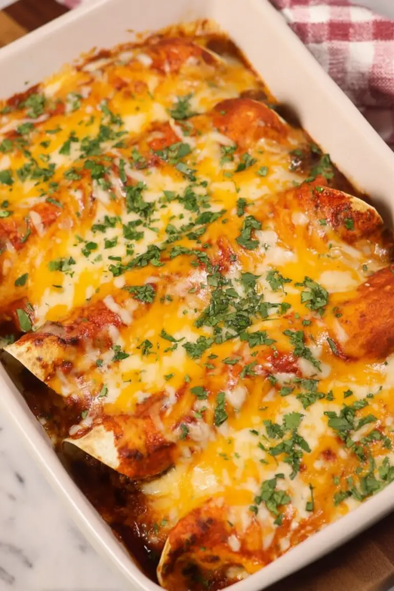 Delicious ground beef enchiladas topped with melted cheese and garnished with cilantro, served with sour cream and salsa on the side.