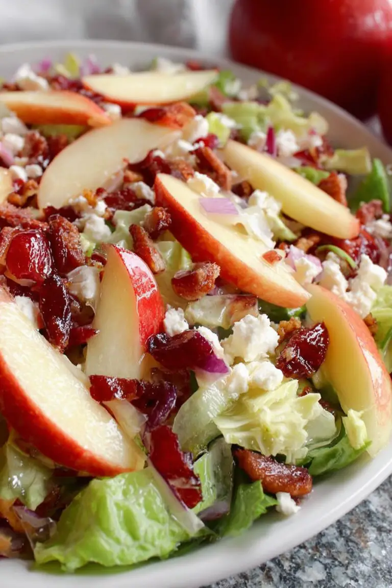 Honeycrisp Harvest Salad featuring Romaine lettuce, Honeycrisp apples, bacon, and cranberries topped with apple cider vinaigrette.