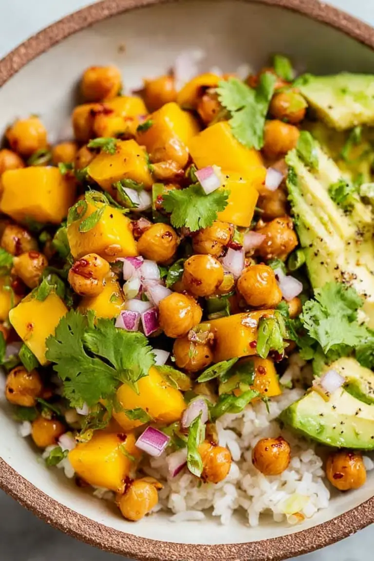 Mango Chickpea Salad with crispy chickpeas, avocado, and fresh cilantro served in a bowl.