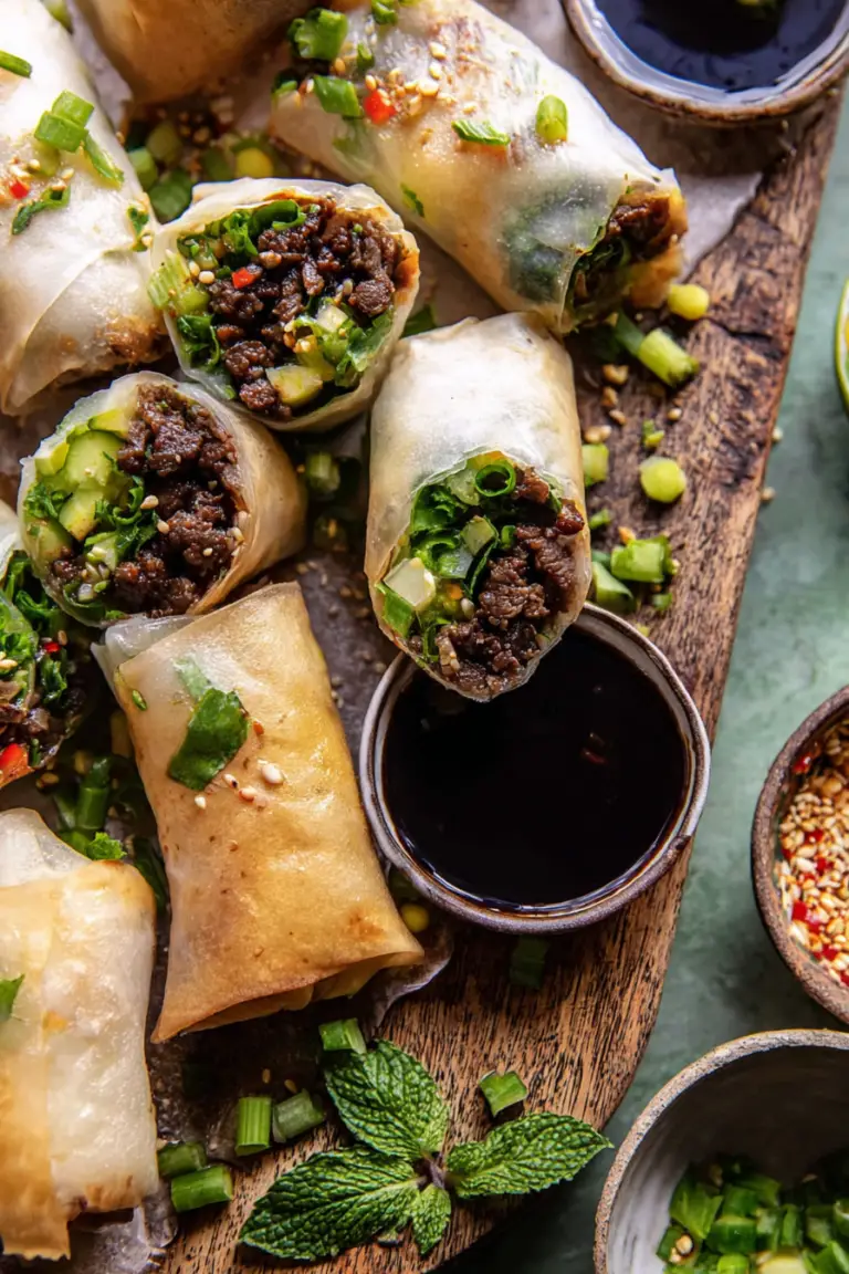 Delicious Thai basil beef rolls served with dipping sauces and fresh herbs.
