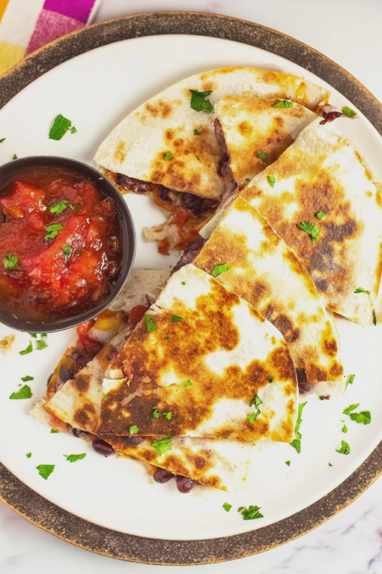 Delicious black bean quesadilla with melting cheese and colorful veggies served with salsa.