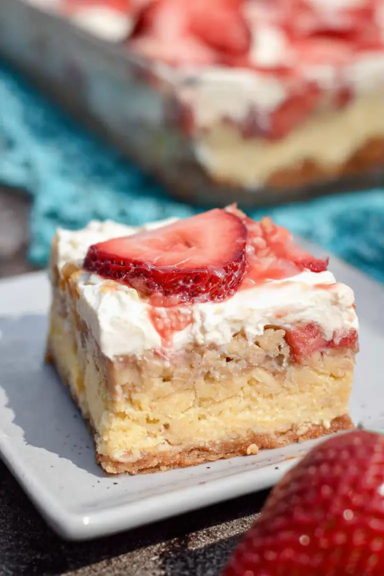 Close-up of a Keto Rhubarb Dream Bar on a plate, highlighting its creamy custard and crust layers.