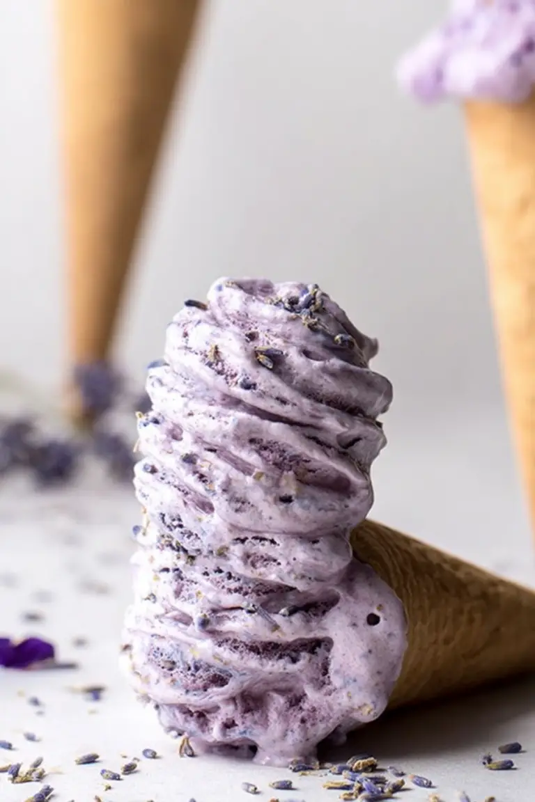 Lavender Earl Grey Ice Cream served in a bowl with lavender sprigs and an earl grey tea bag.