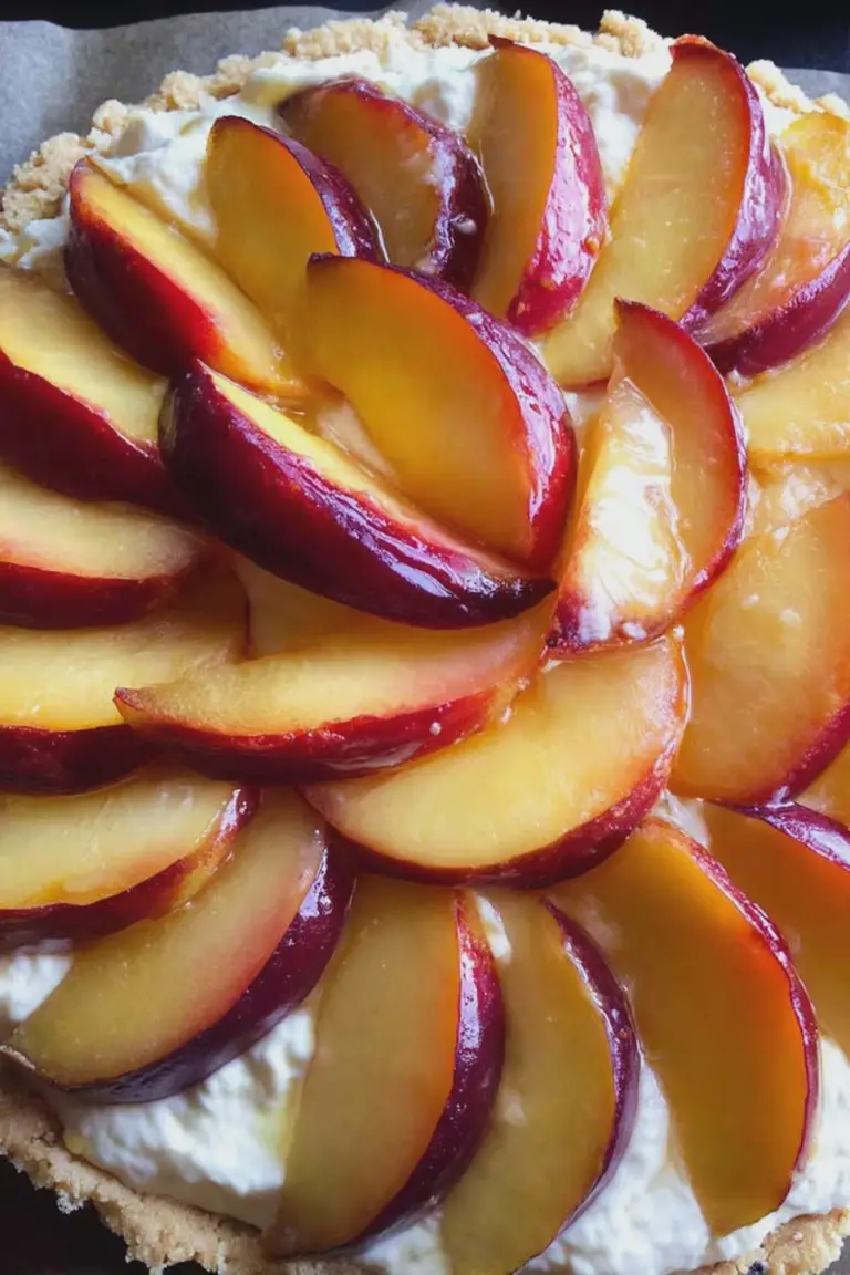Nectarine and mascarpone tart with fresh nectarine slices on a wooden table