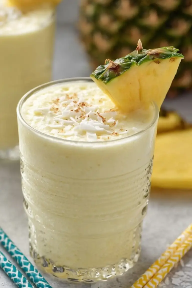 Delicious Piña Colada Smoothie garnished with pineapple and cherry, perfect for a tropical breakfast.