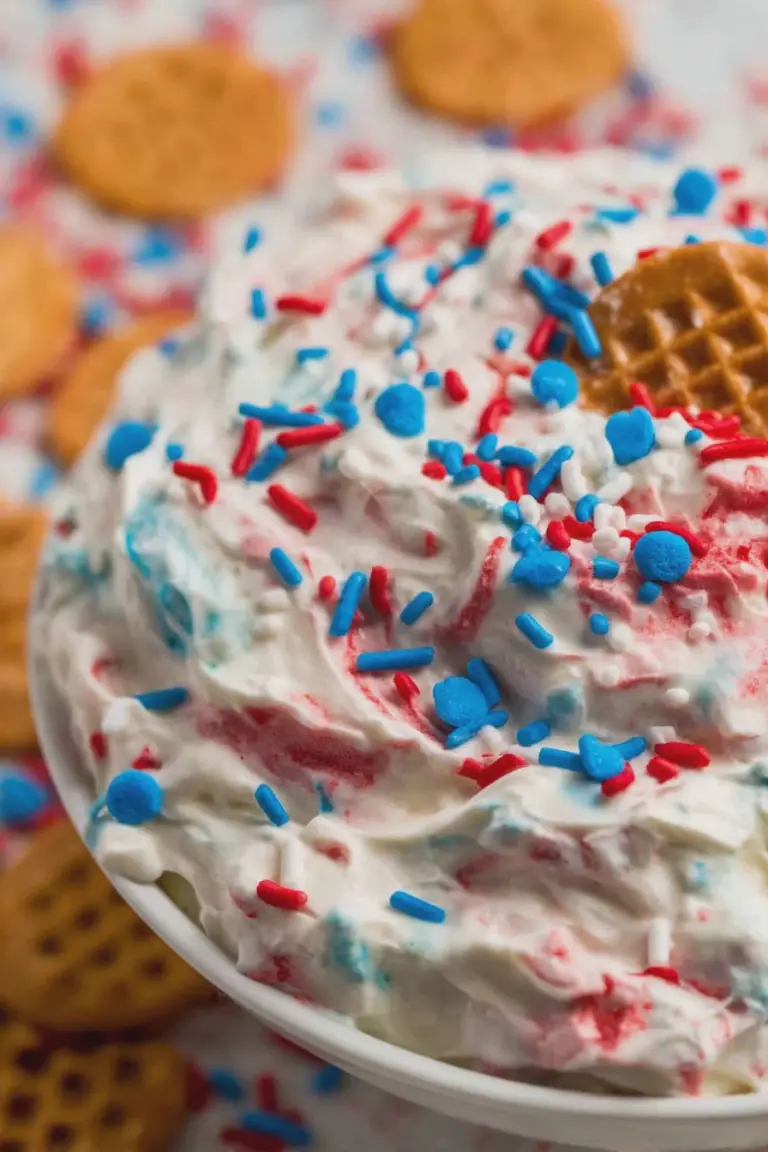 Red, white, and blue funfetti dip served with graham crackers and pretzels, perfect for 4th of July celebrations.