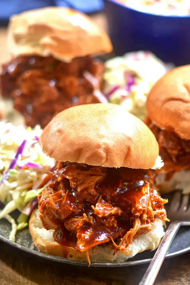 Slow Cooker Hawaiian Chicken served on a sandwich roll with pineapple and salad, showcasing a delicious meal.
